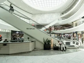 Retail atrium with escalators and natural light