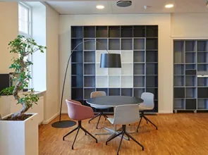 Office meeting corner with round table and shelving